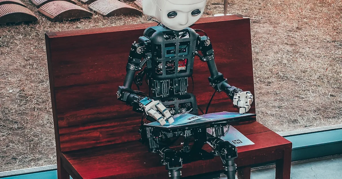 A robotic hand and a human hand reaching toward a glowing screen of code